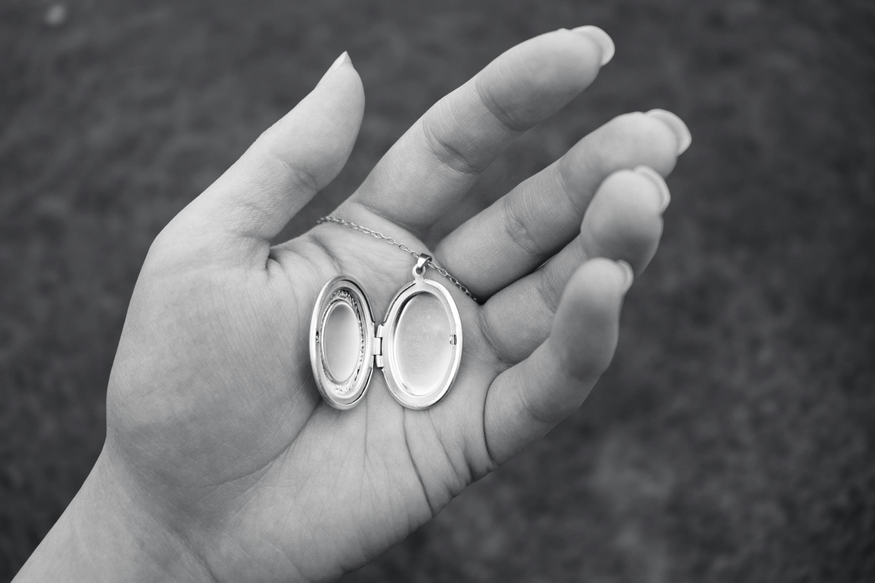 A hand holding an open locket